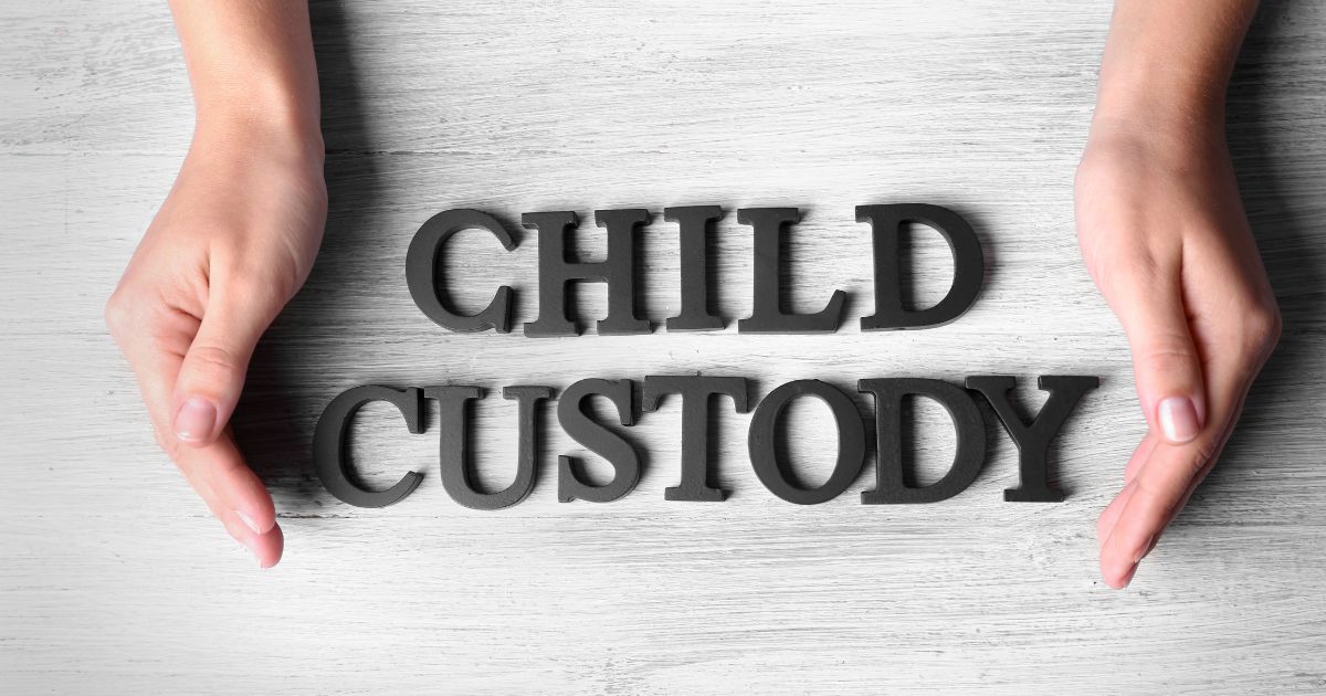 Hands cupping child custody sign