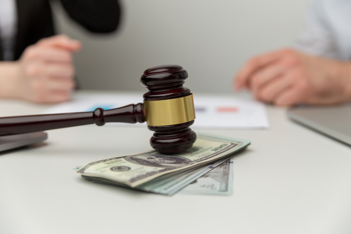 Closeup view of wooden gavel and money - spousal support concept