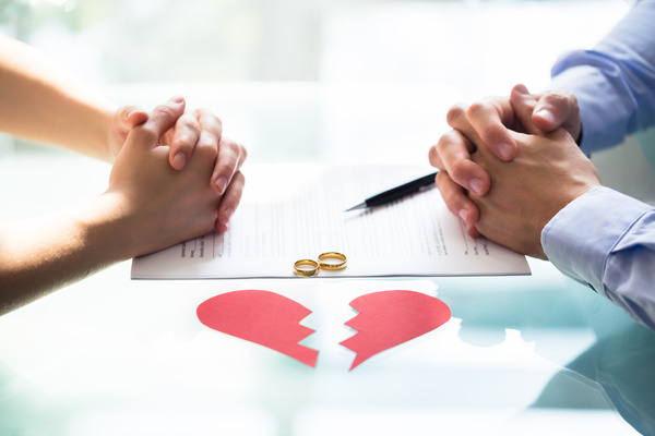 Couple's Hand On Divorce Paper